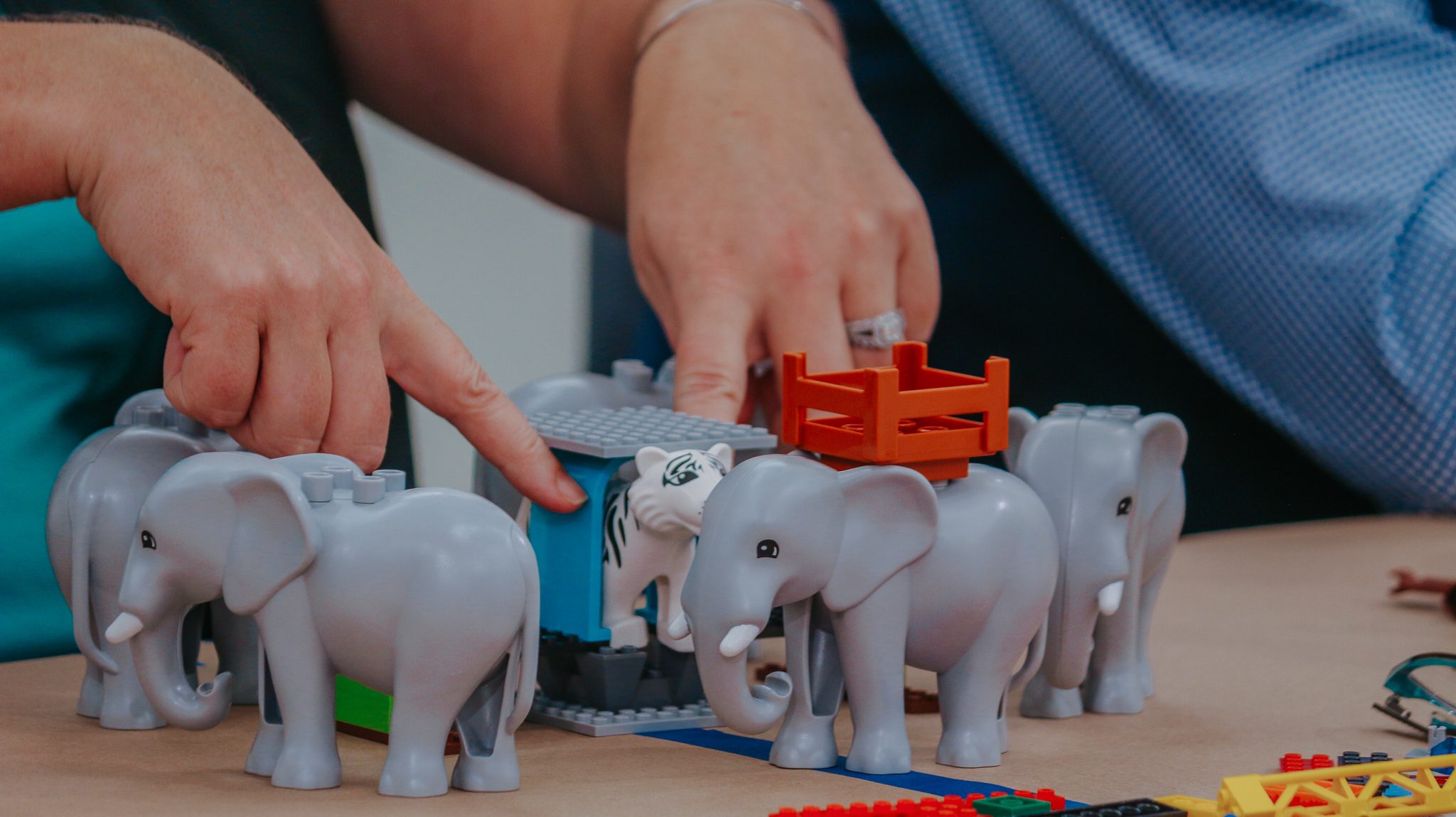 Hands building a shared model in a LEGO Serious Play session