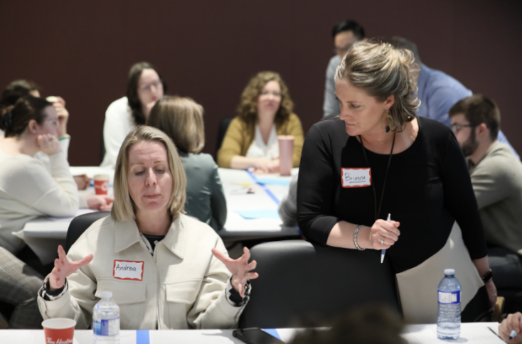 A team co-creating and refining ideas together around a table